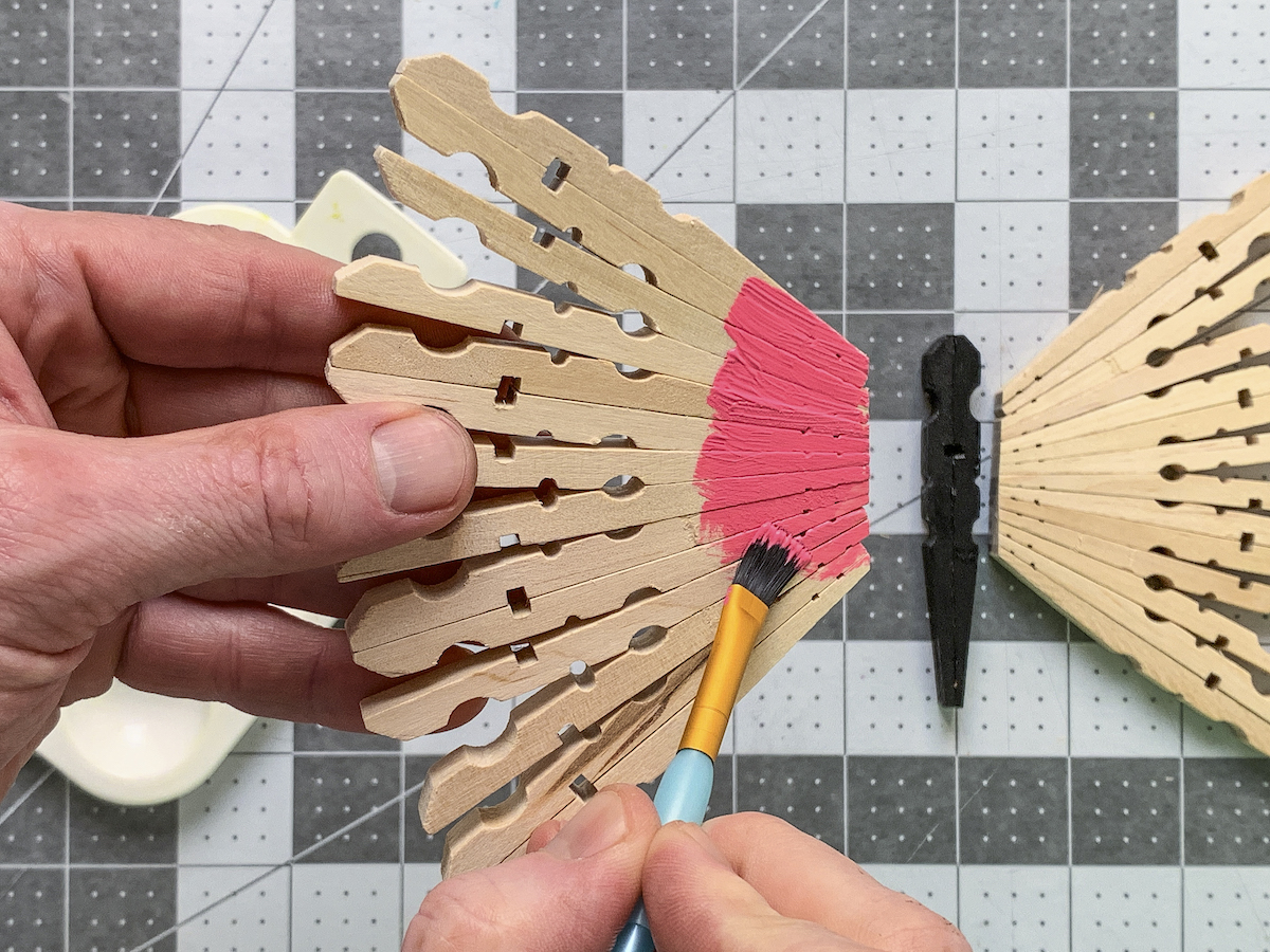 Painting clothespin wings with pink acrylic paint