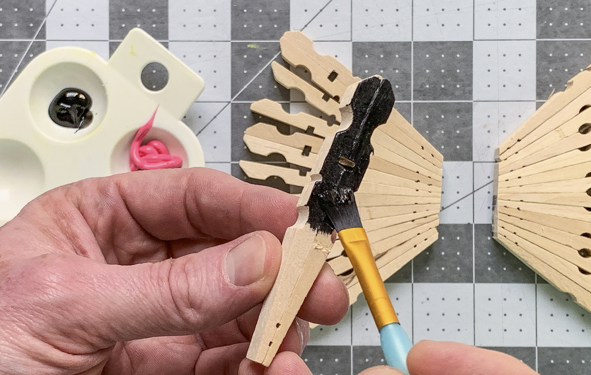Painting clothespins with black acrylic paint