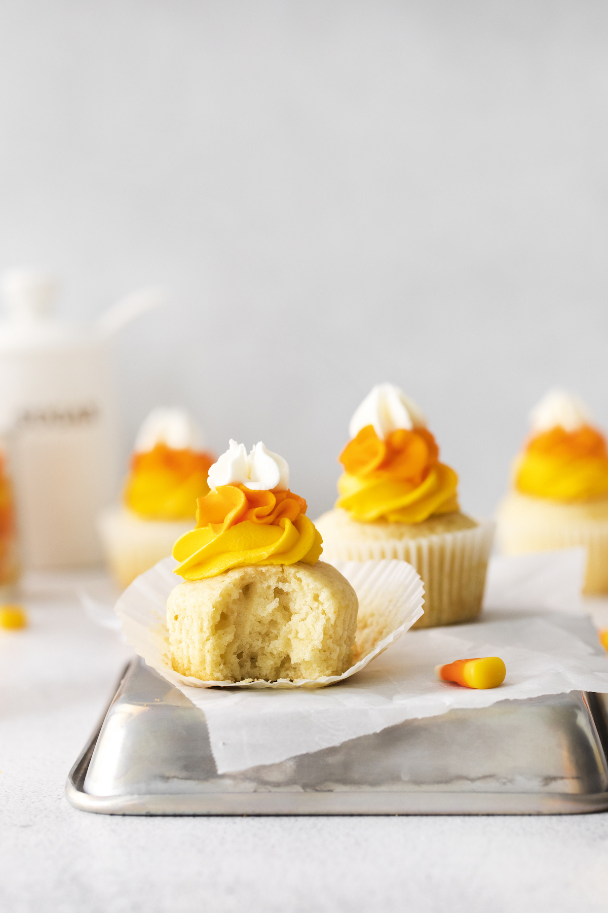 Candy corn cupcake with a bite out of it
