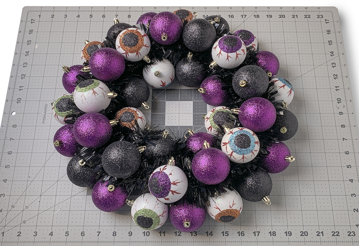 Finished Halloween ornament wreath laying on a craft mat