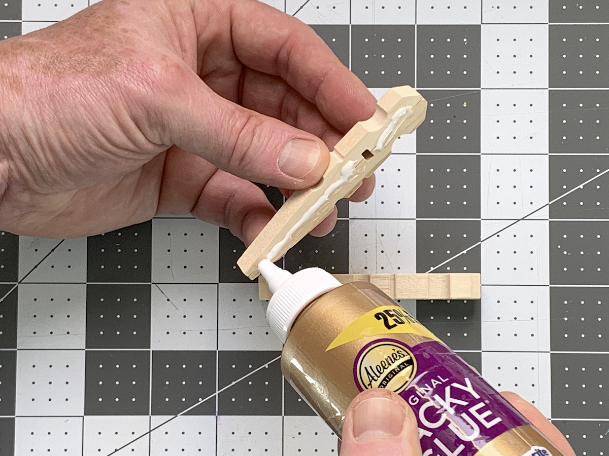 Gluing two clothespins together with craft glue