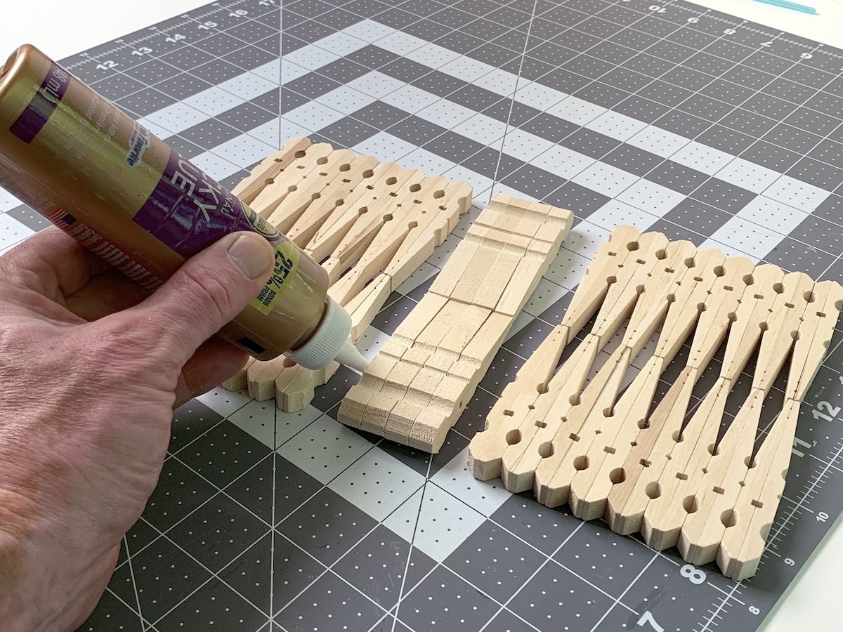 Placing glue on one end of the clothespins