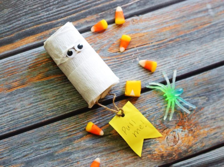 mummy pinata surrounded by candy