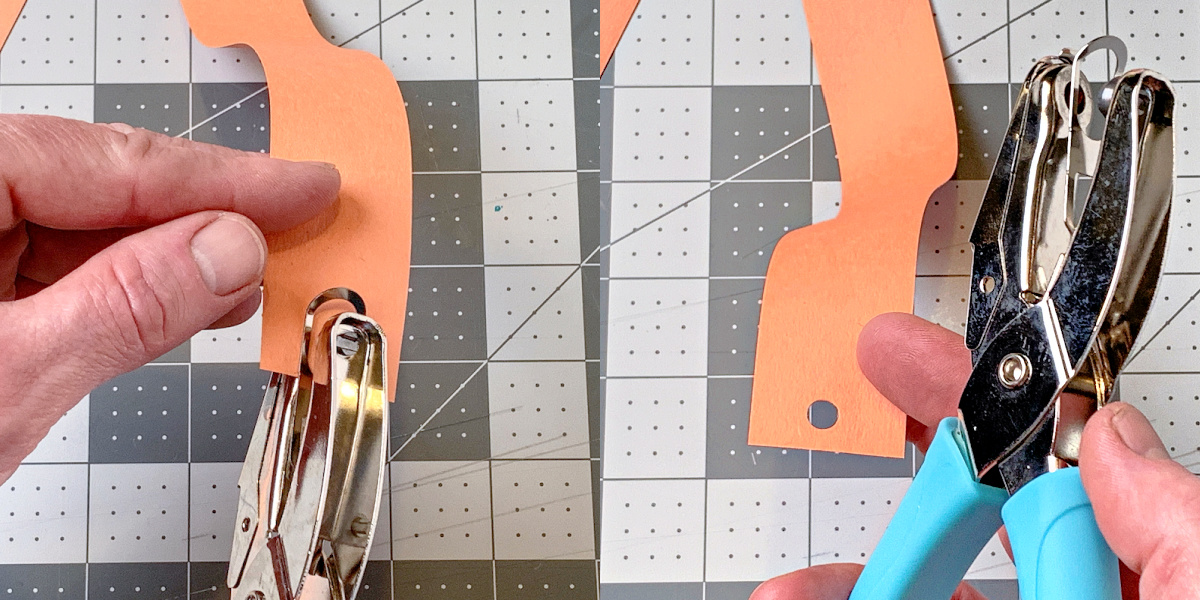 Punching a hole in the end of a strip of orange construction paper