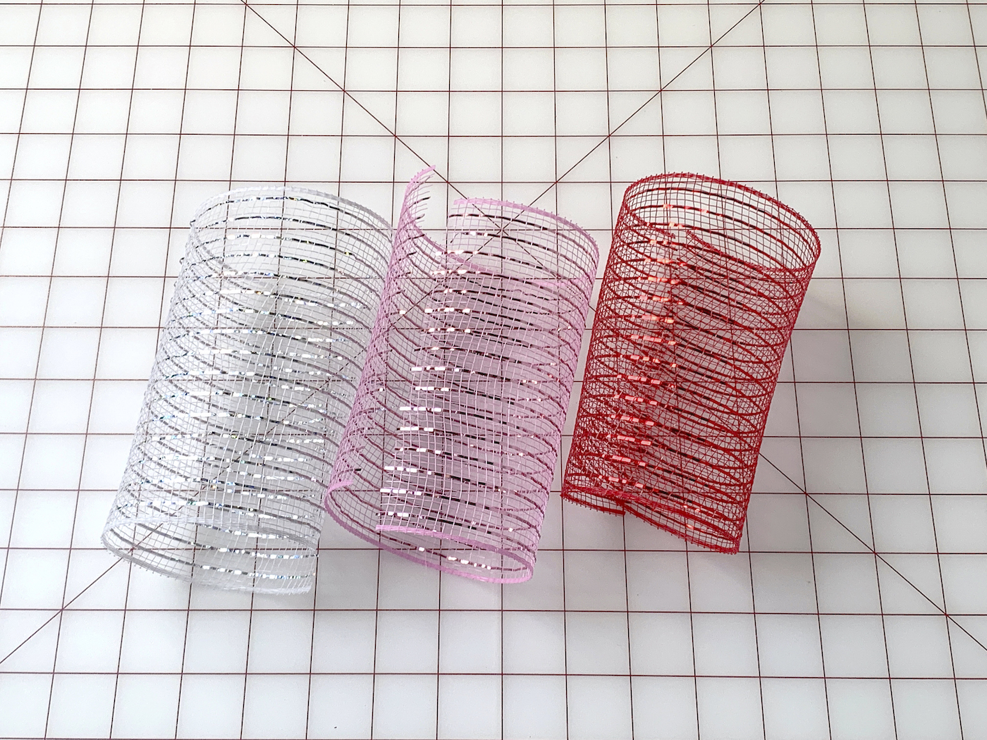 Cut pieces of deco mesh laying on a cutting mat