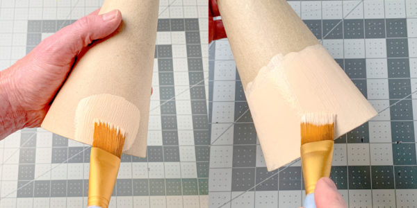 Painting a paper mache cone with light skin tone craft paint