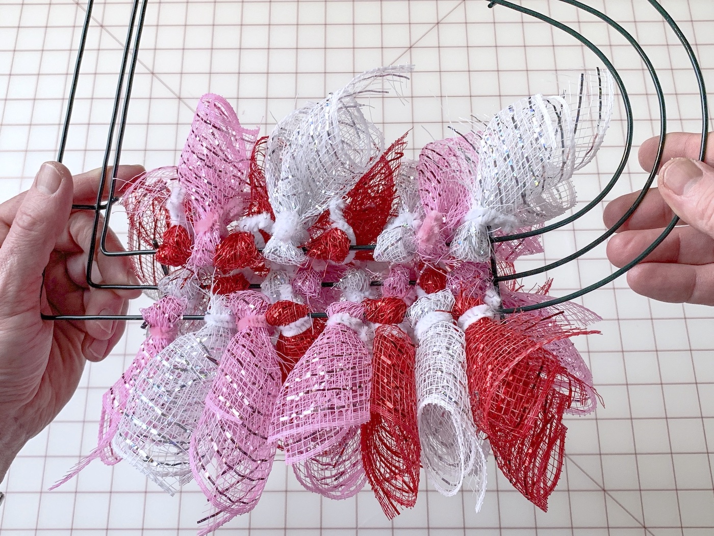 Red, pink, and white mesh pieces attached to a wire wreath