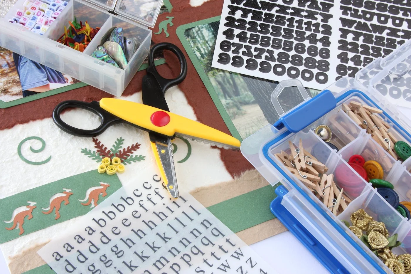 Craft-supplies-including-stickers-and-decorative-scissors-laying-on-a-work-surface