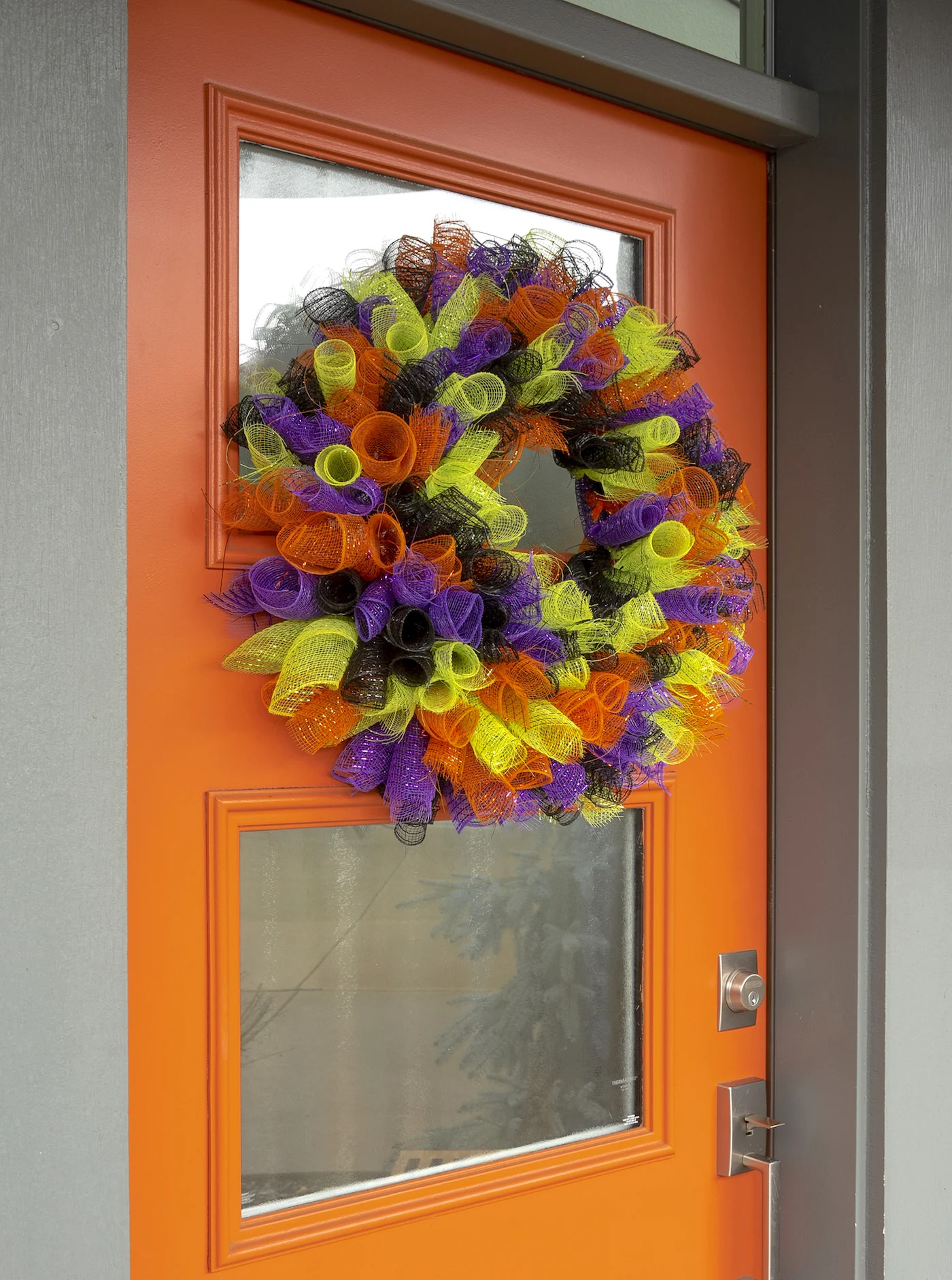 diy halloween mesh wreath on an orange front door