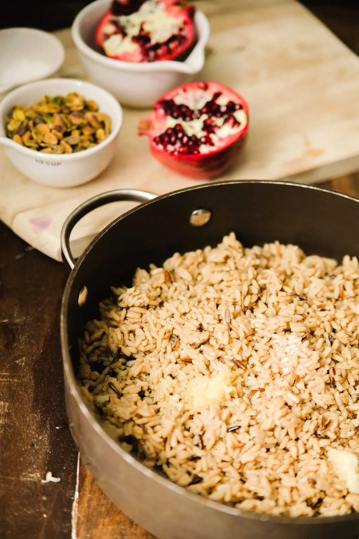 Wild rice cooking in a pan with crushed garlic