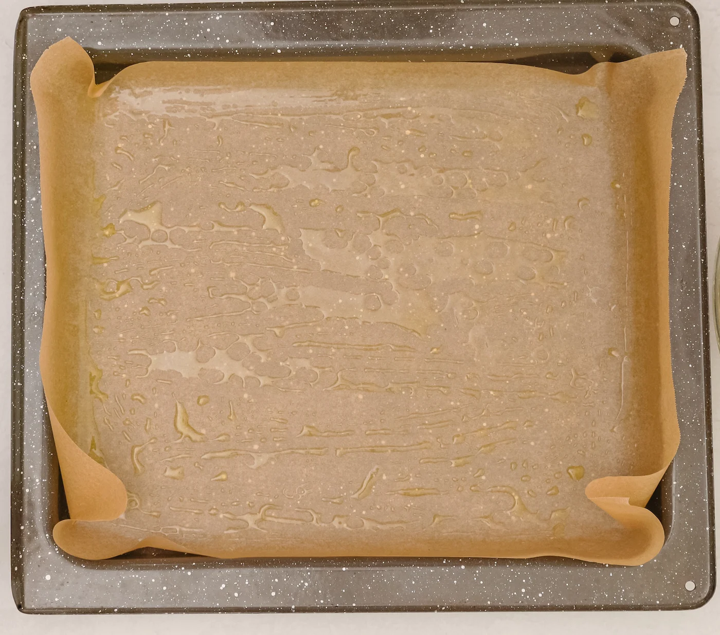Baking-pan-lined-with-parchment-paper-and-greased