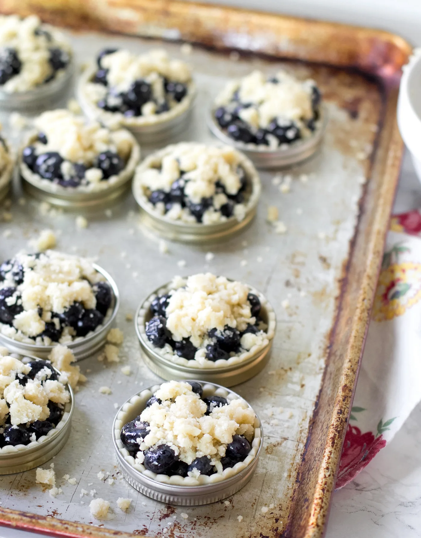 Topping the blueberries with crumble