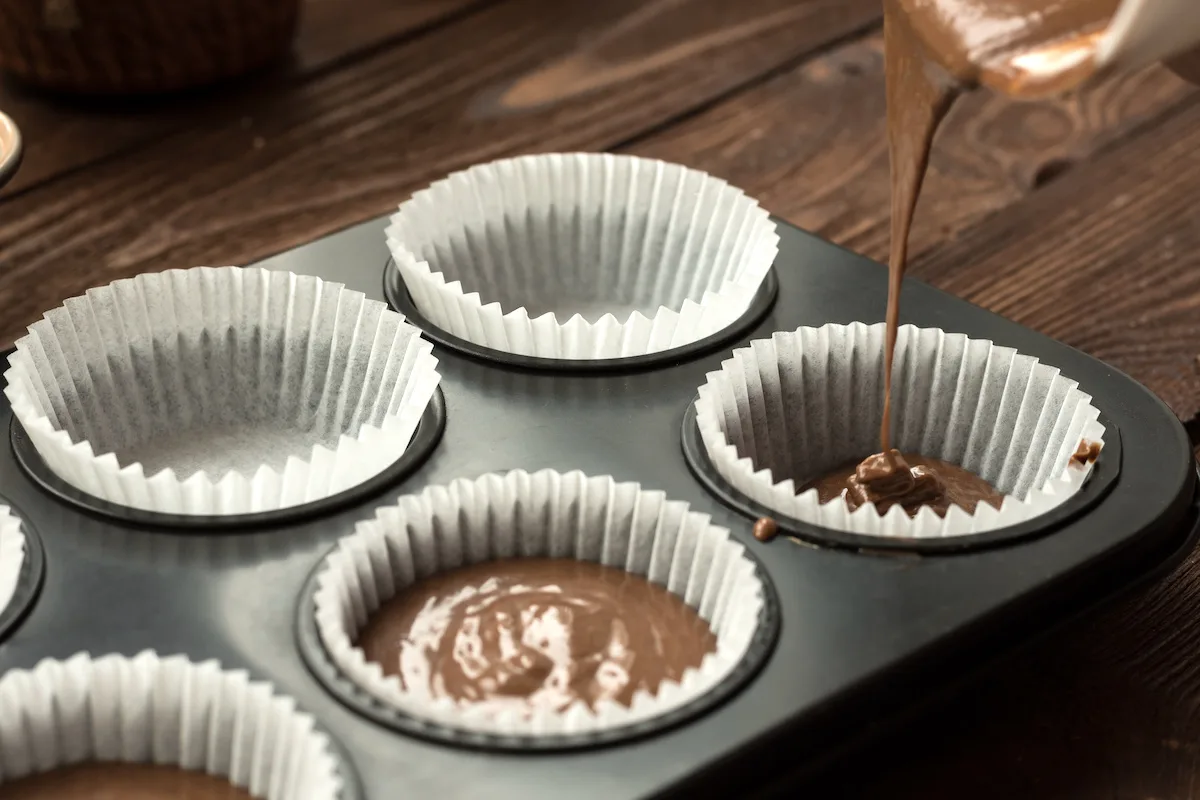Pouring-batter-into-cupcake-liners