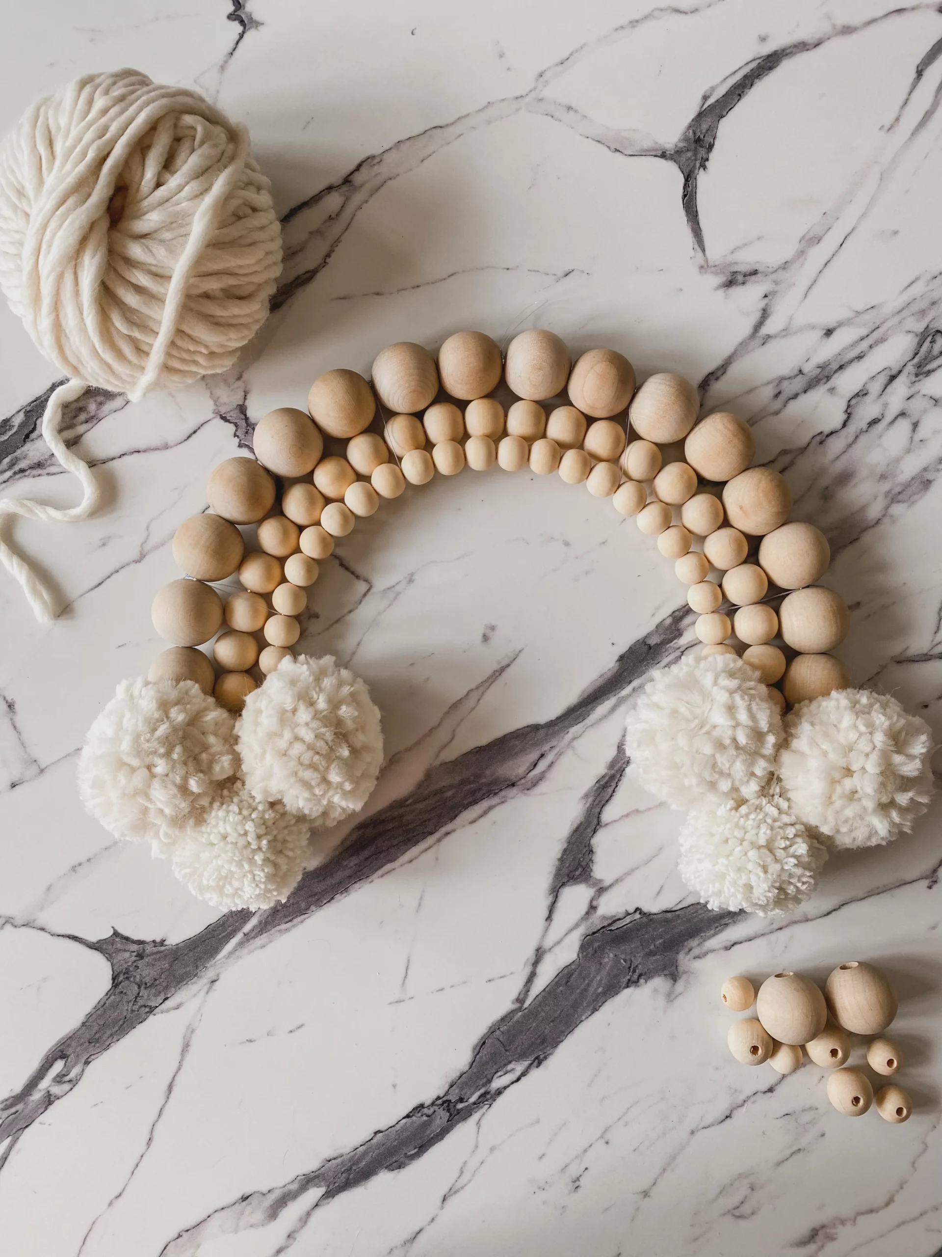 wood bead and pom pom rainbow wall hanging