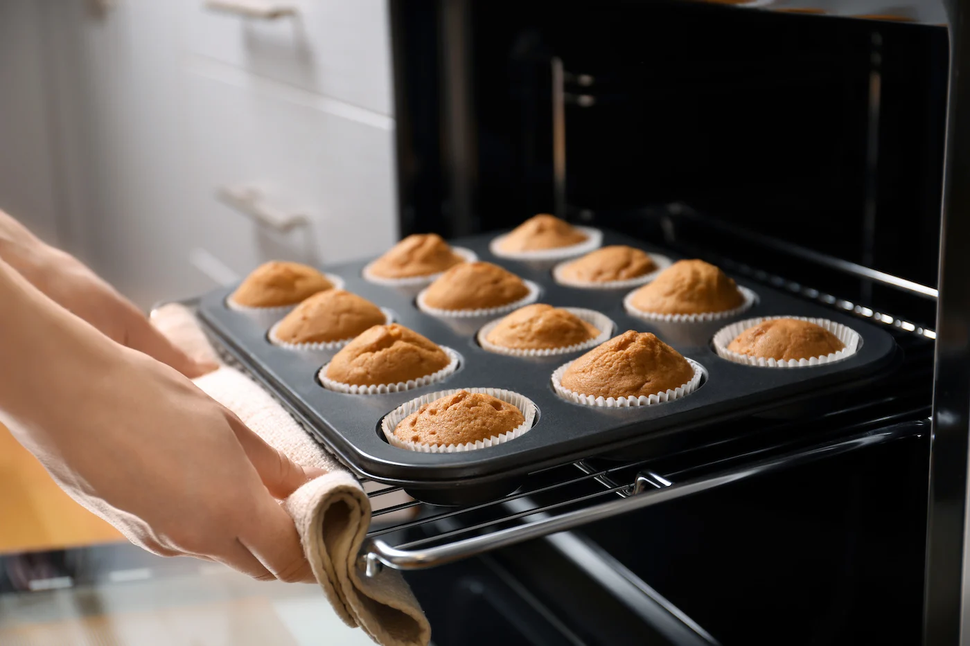 Baked-cupcakes-being-removed-from-the-oven