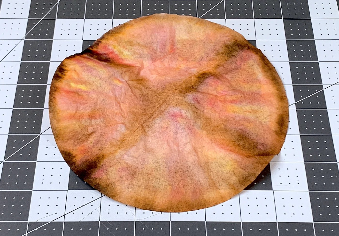 Dried coffee filter dyed with markers