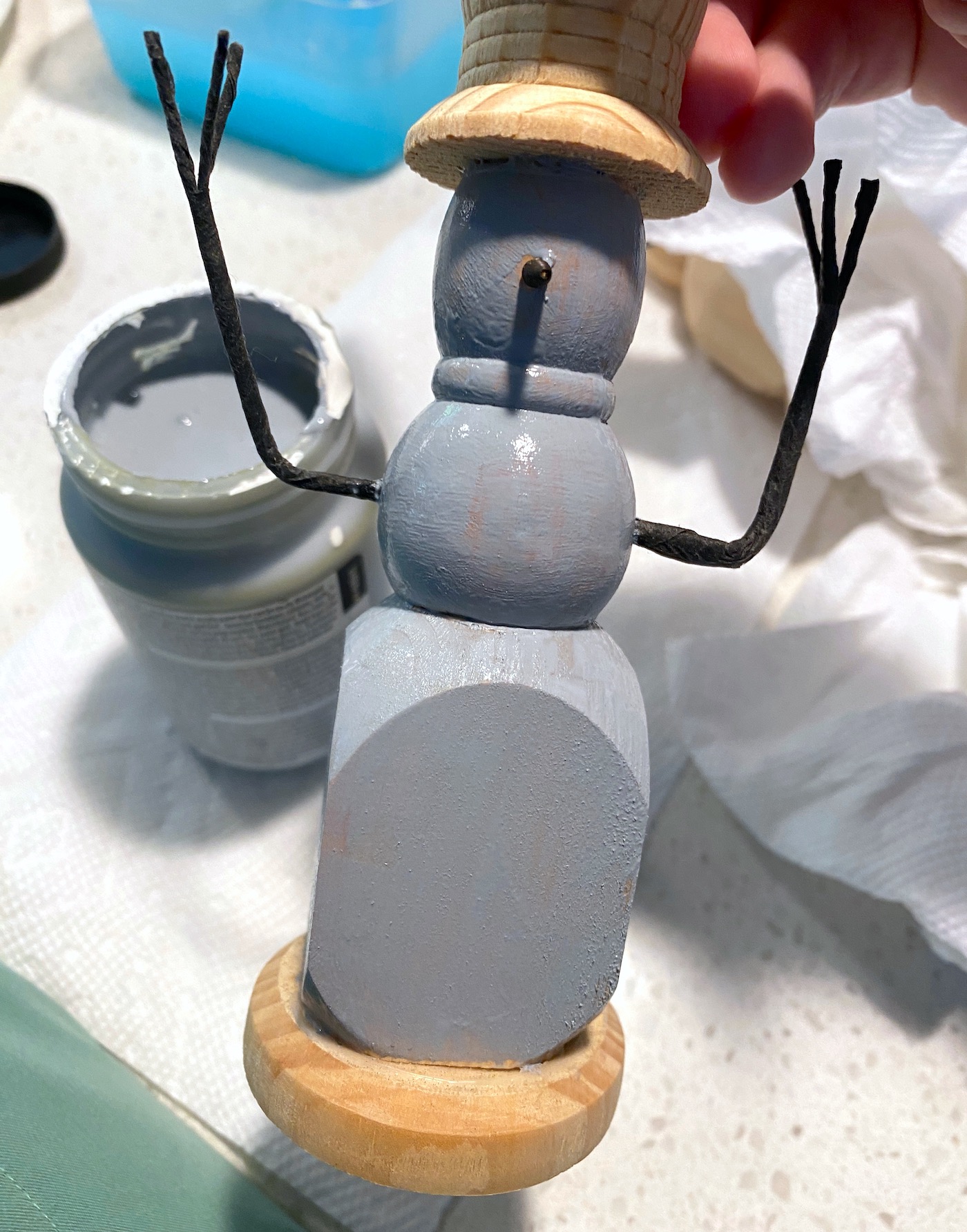 Wood candlestick painted with gray paint