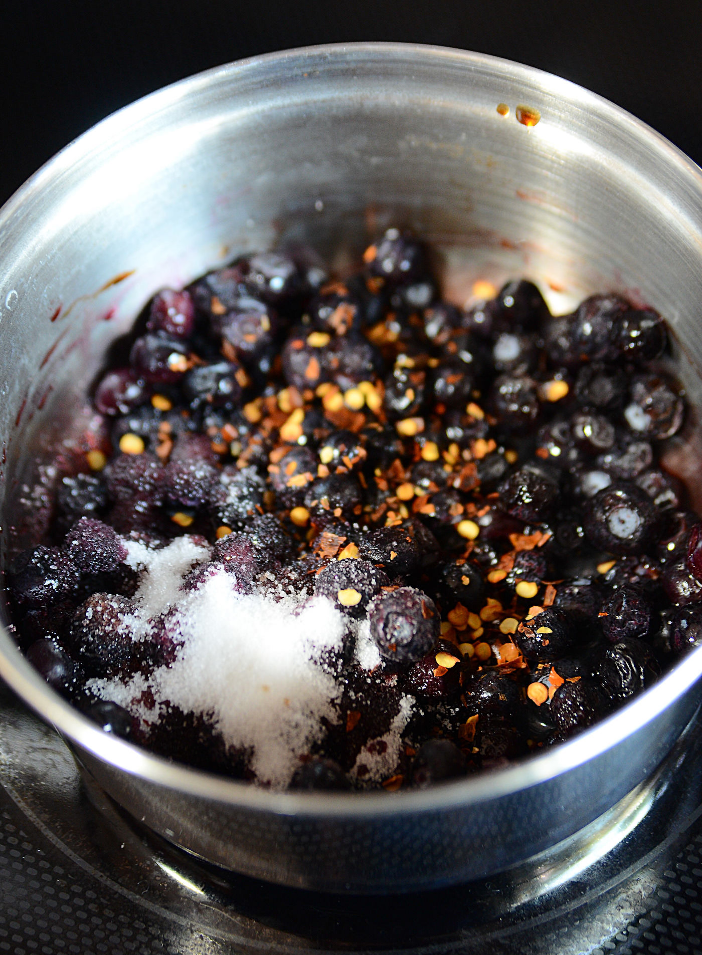 Blueberries, spices, and sugar in a saucepan
