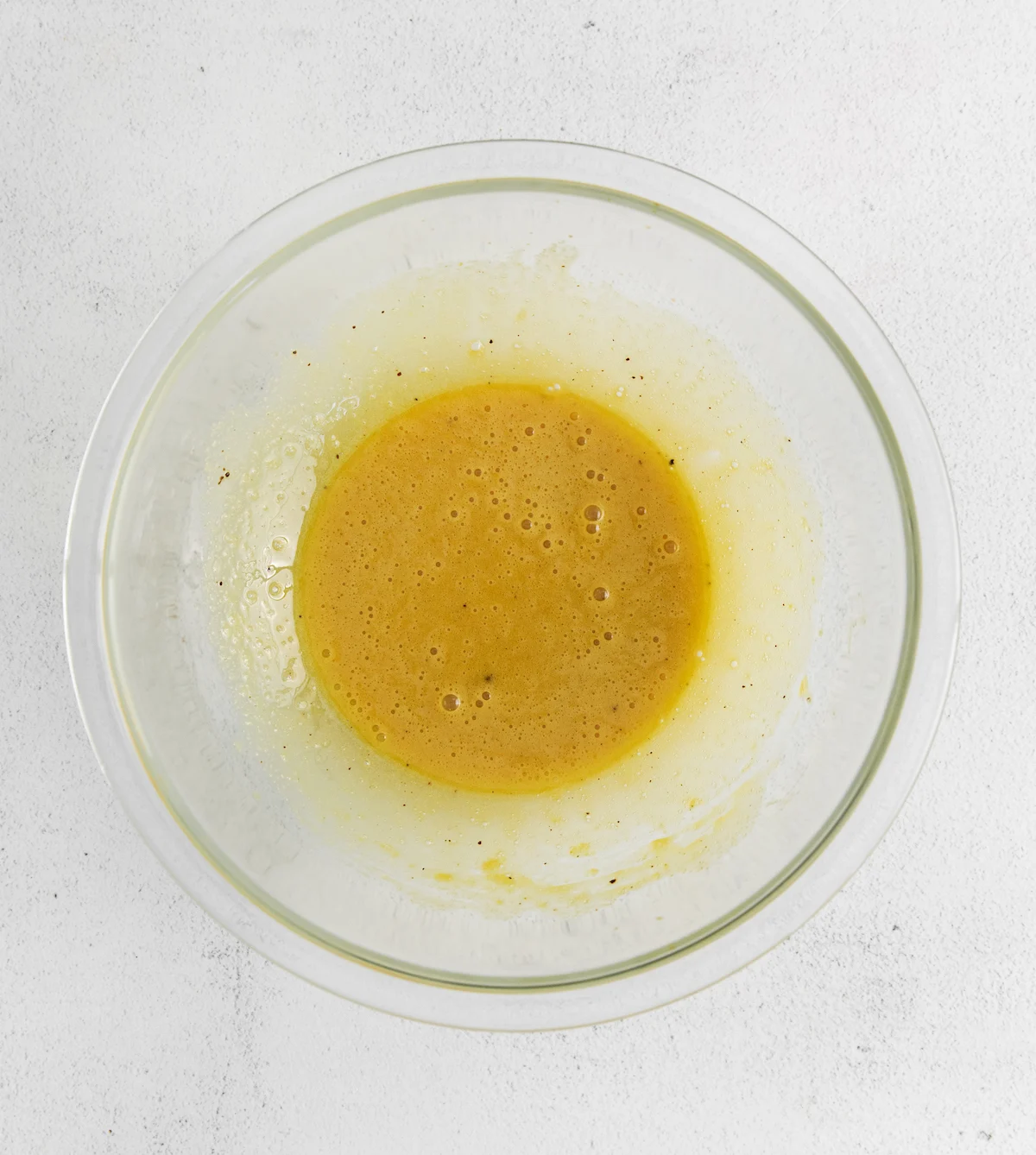 Egg yolks, sugar, and vanilla mixed in a bowl
