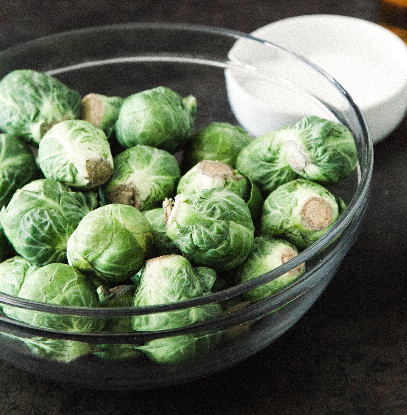 glass bowl of raw brussels sprouts