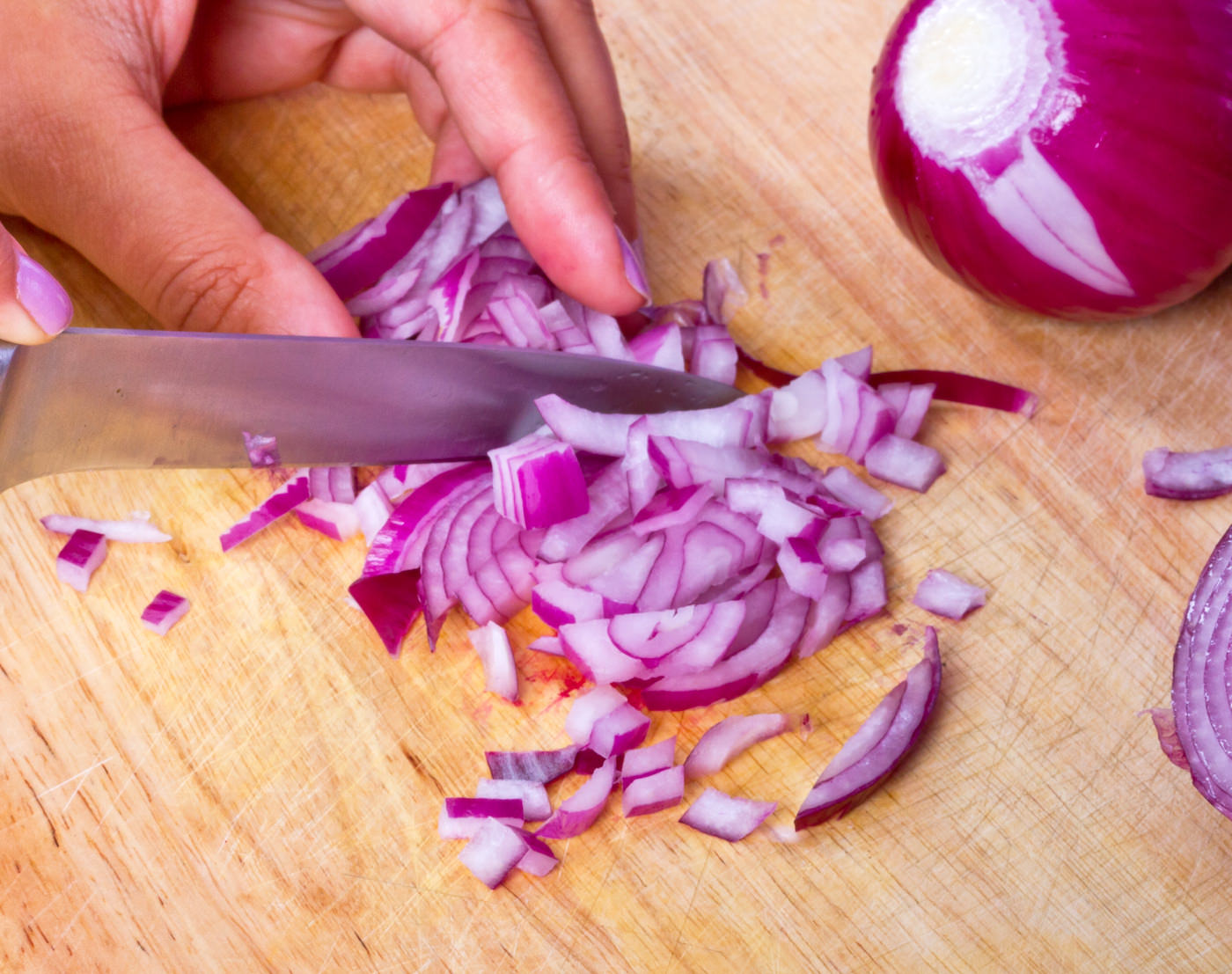 Chopping red onion on the kitchen cutting board
