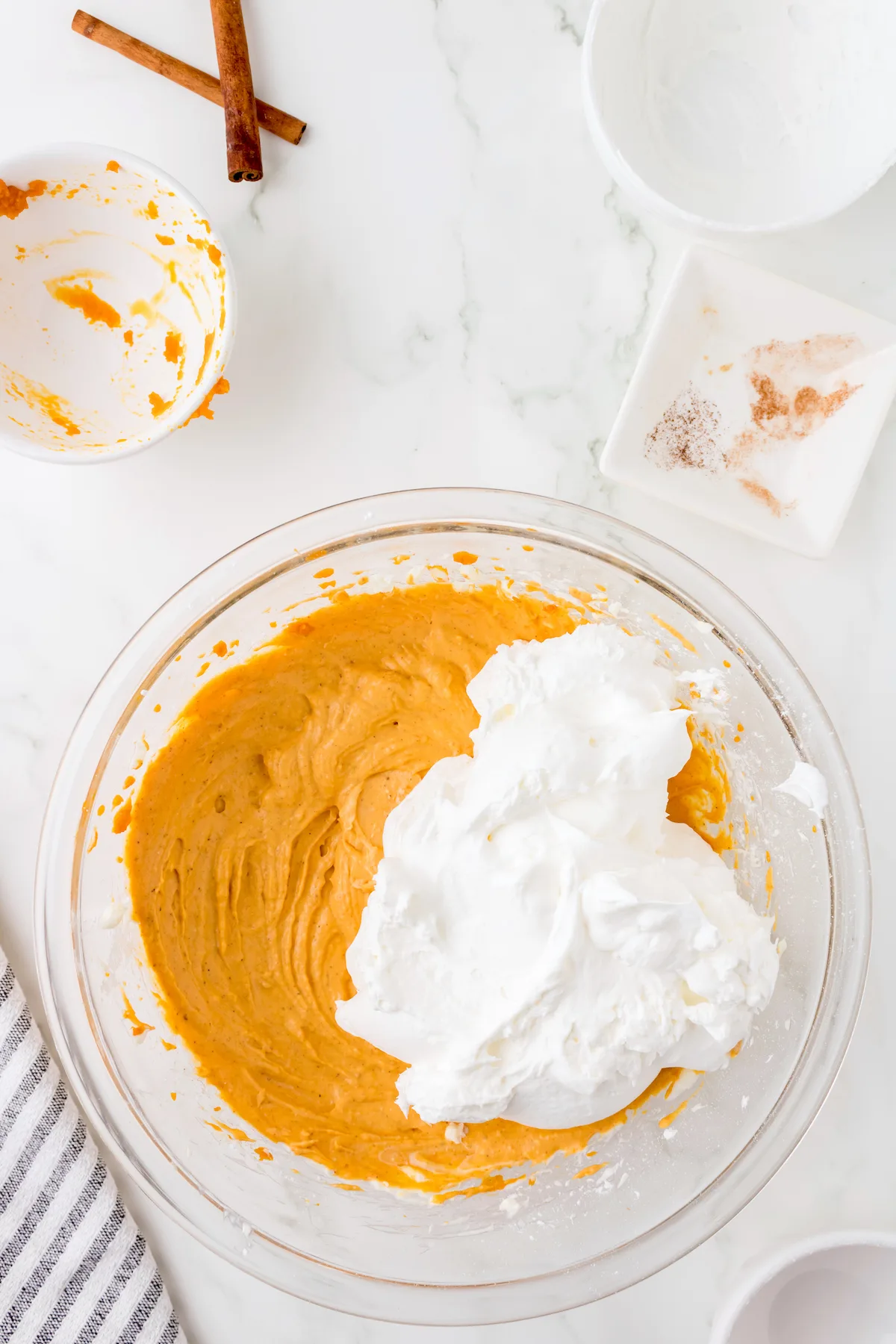 Adding whipped cream to the pumpkin dip