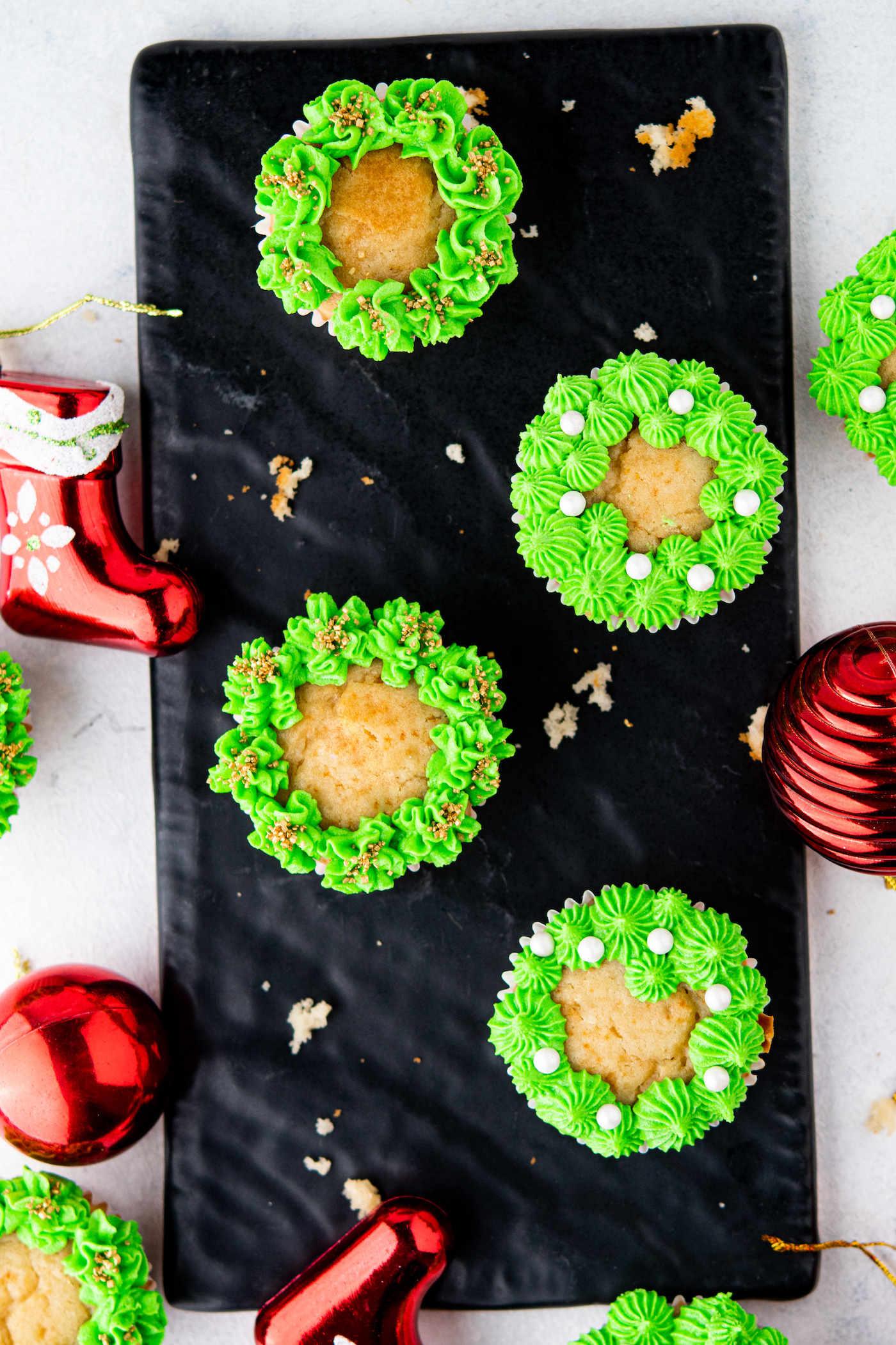 Christmas wreath cupcakes on a black tray
