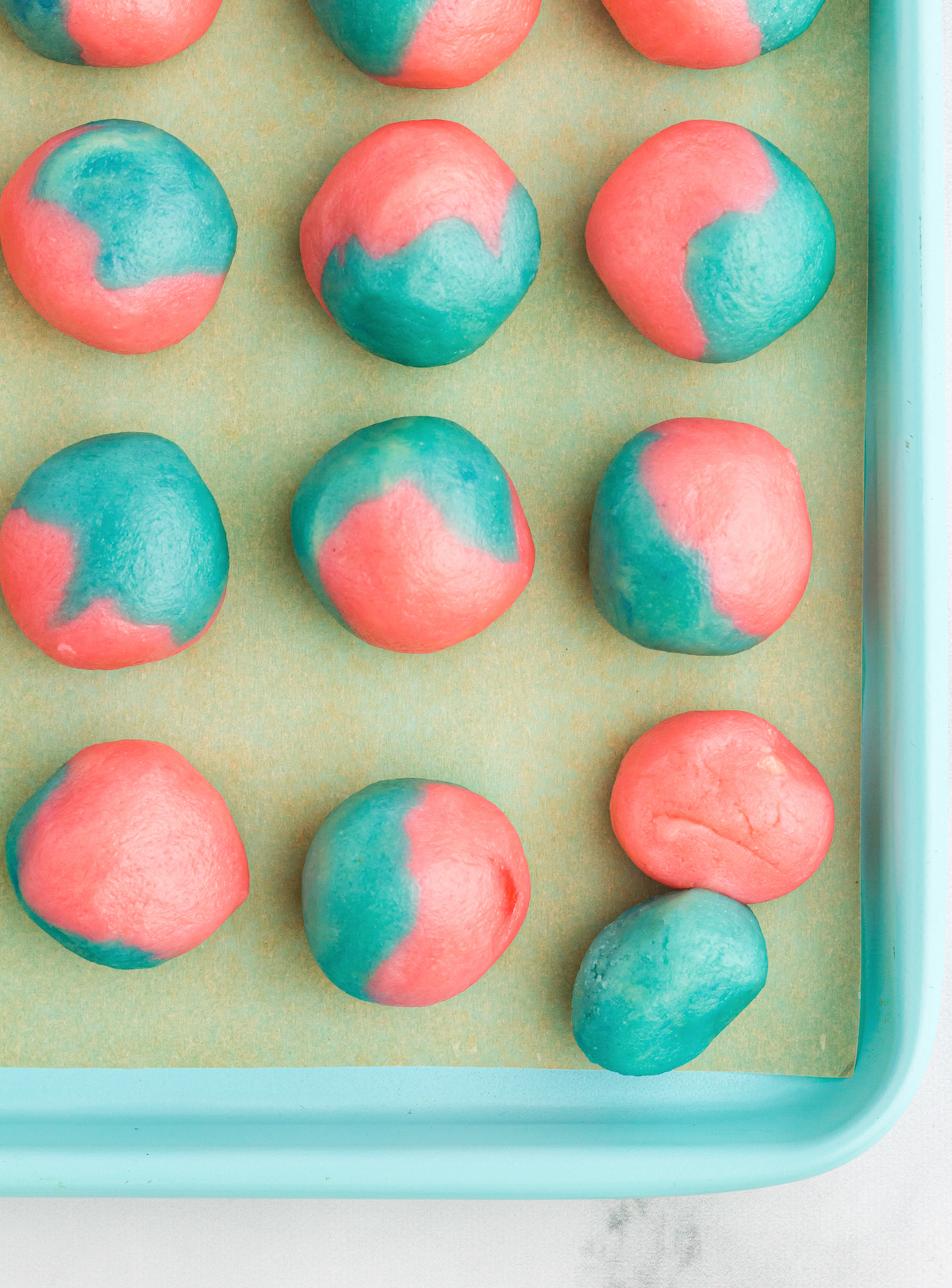 Forming the pink and blue dough into balls