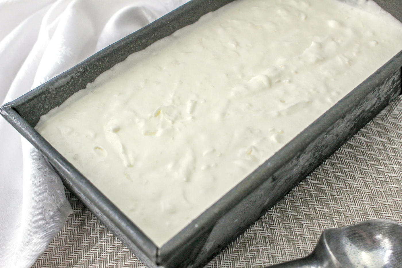 Ice cream smoothed into a loaf pan and ready to freeze