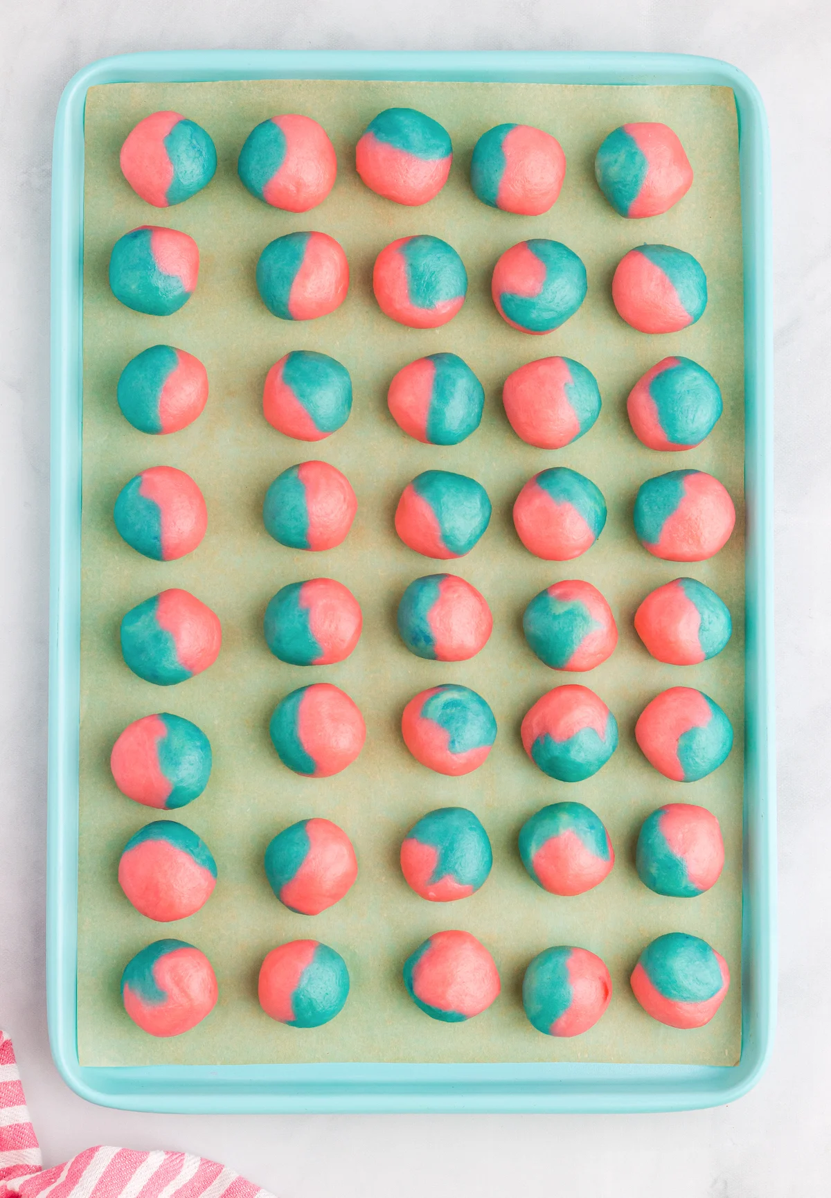 Pink and blue balls chilling on the baking mat