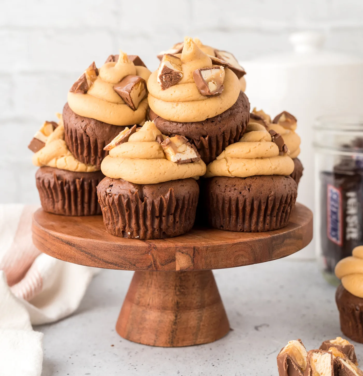 Snickers cupcakes on a cake plate