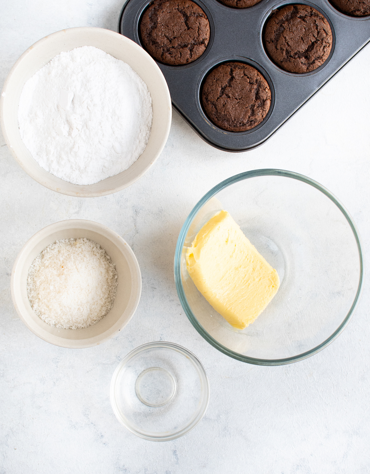 Butter, chocolate cupcakes, coconut, extract, and powdered sugar