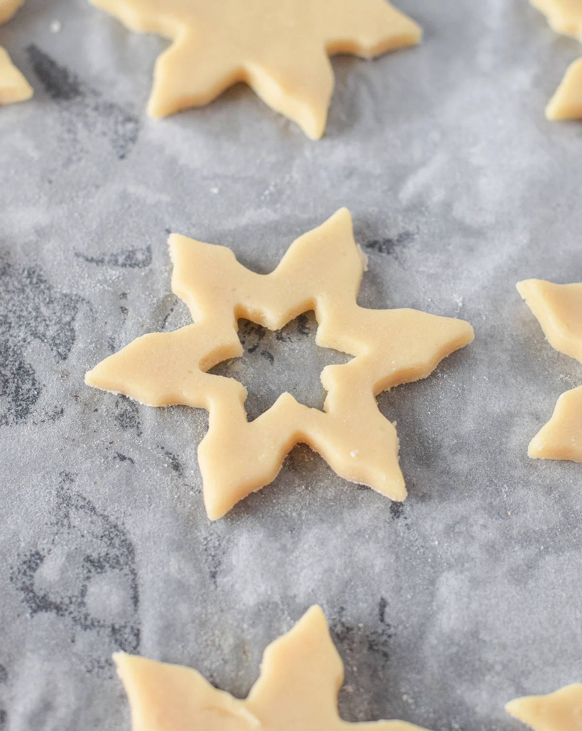 Cut out stars from cookie dough on parchment paper