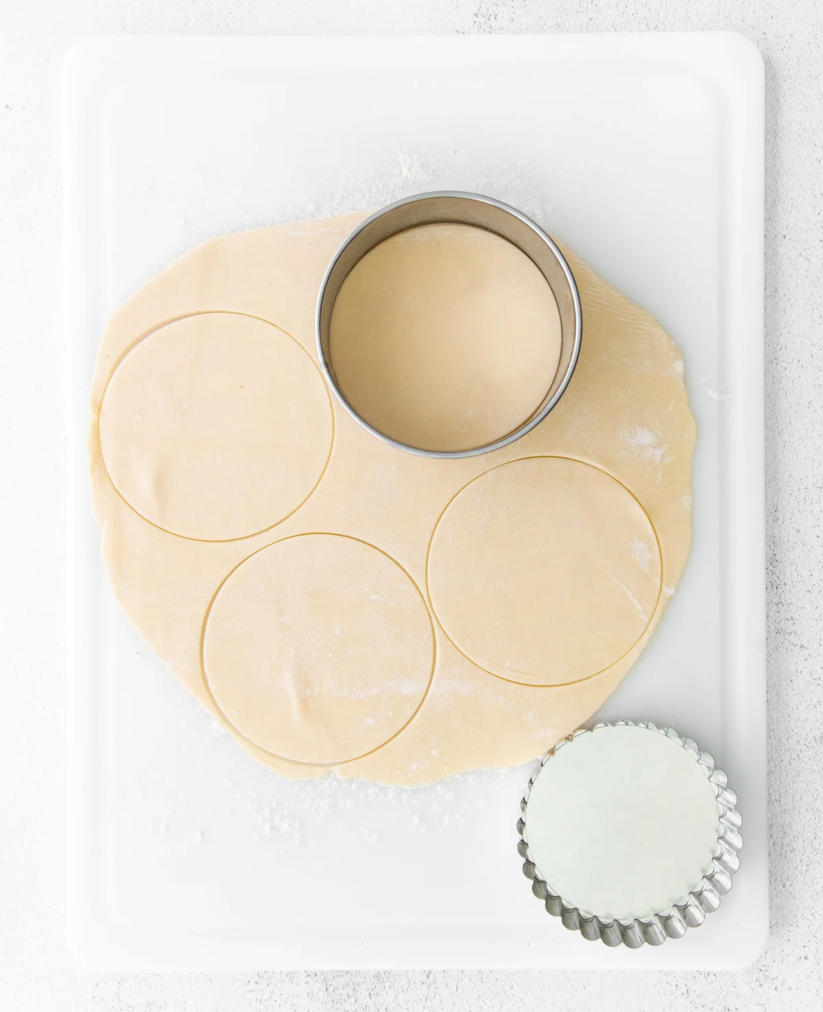 Cutting circles out of pie crust with a cookie cutter