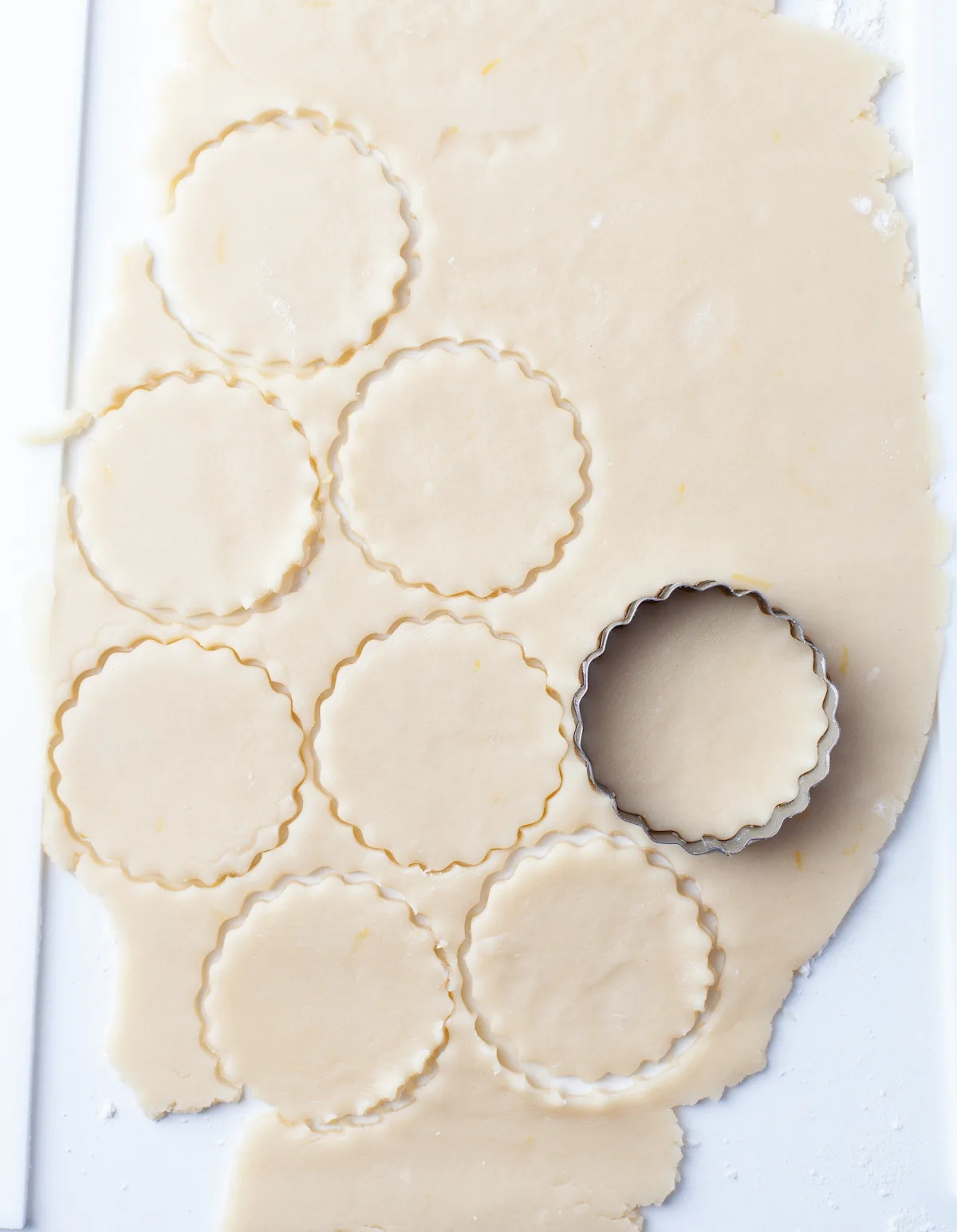Lemon cookies being cut out of dough
