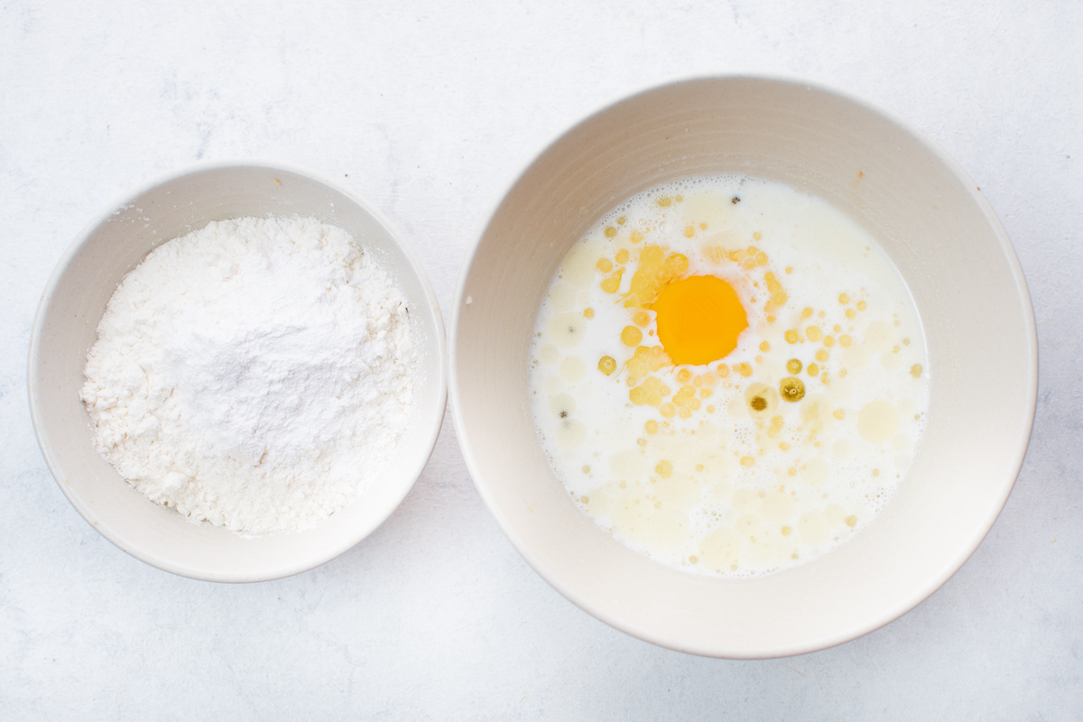 Milk, egg, and wet ingredients with a separate bowl of dry ingredients