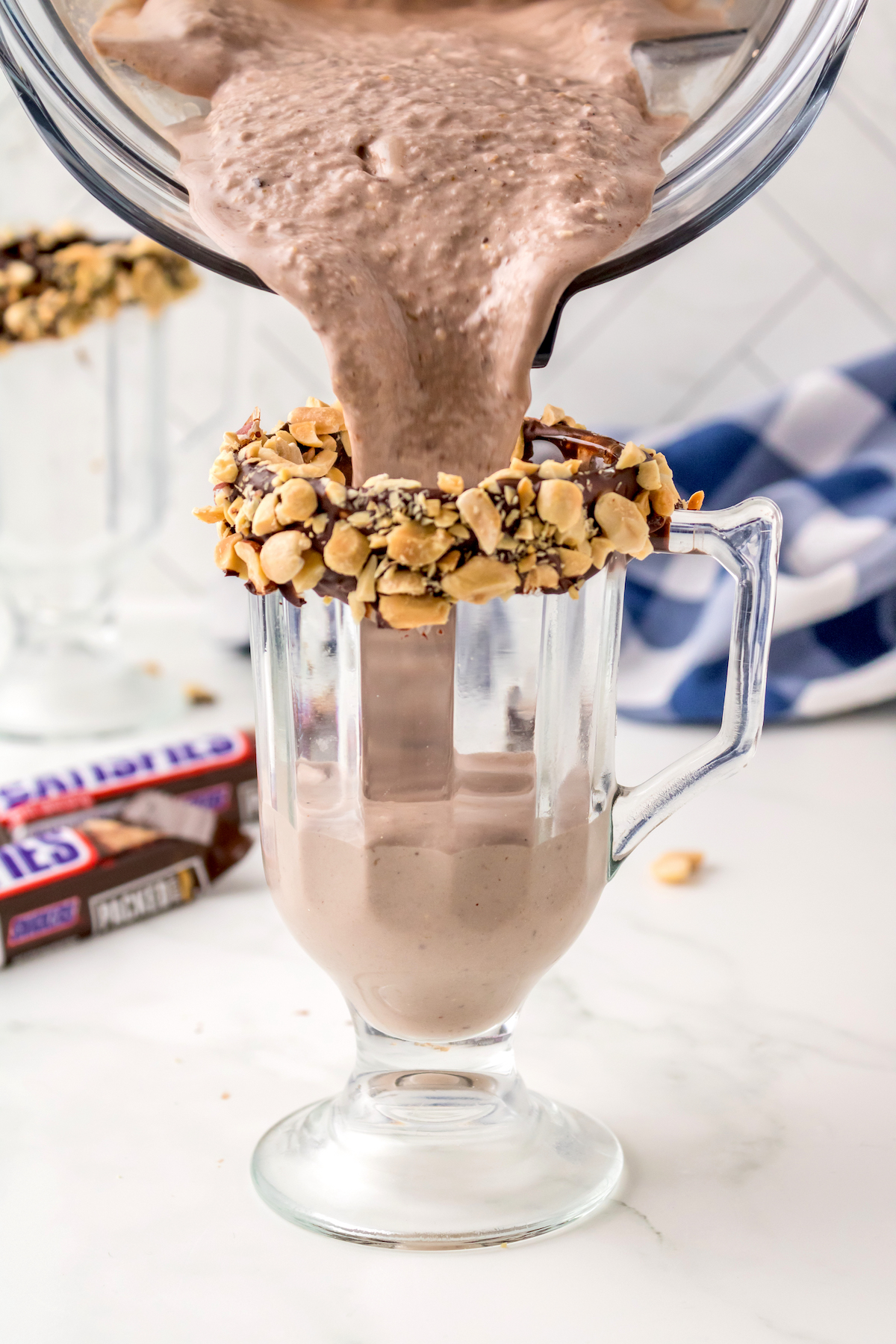 Pouring the Snickers milkshake into the glass