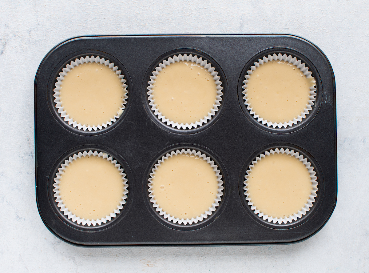 Vanilla cupcake batter in a pan with liners