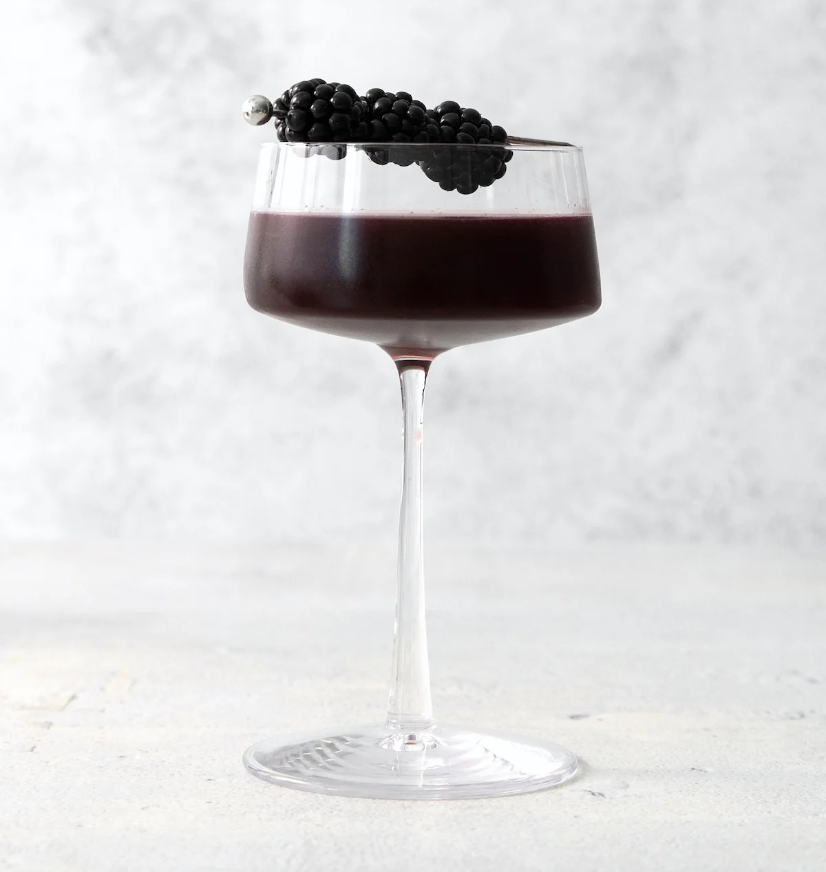 black widow cocktail strained into a glass