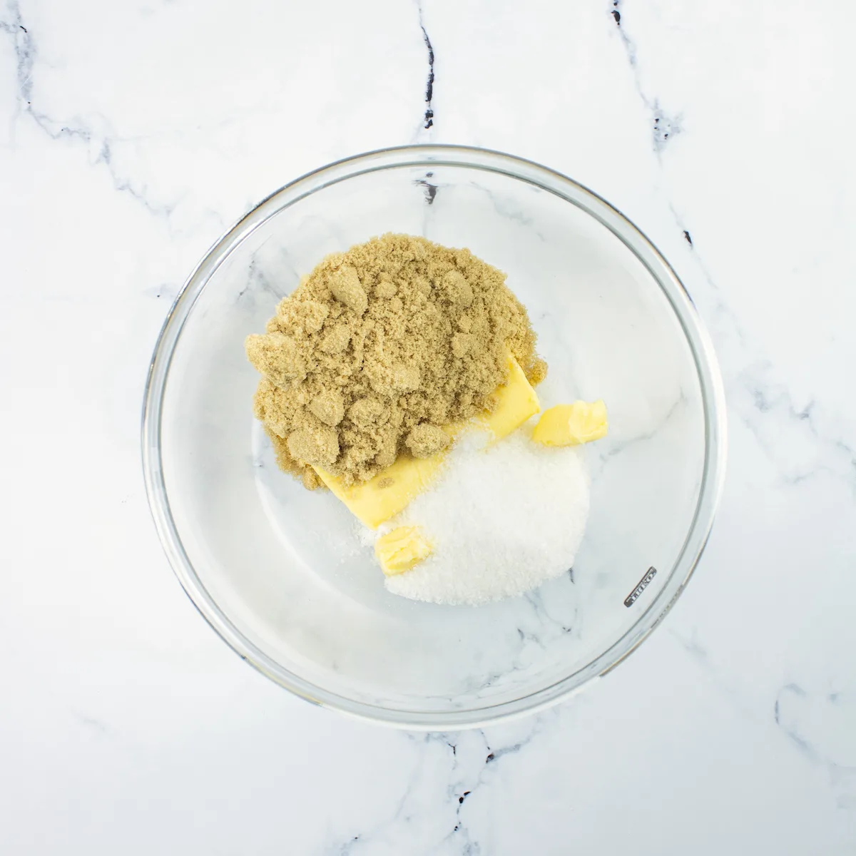brown sugar, butter, and granulated sugar in a clear glass bowl