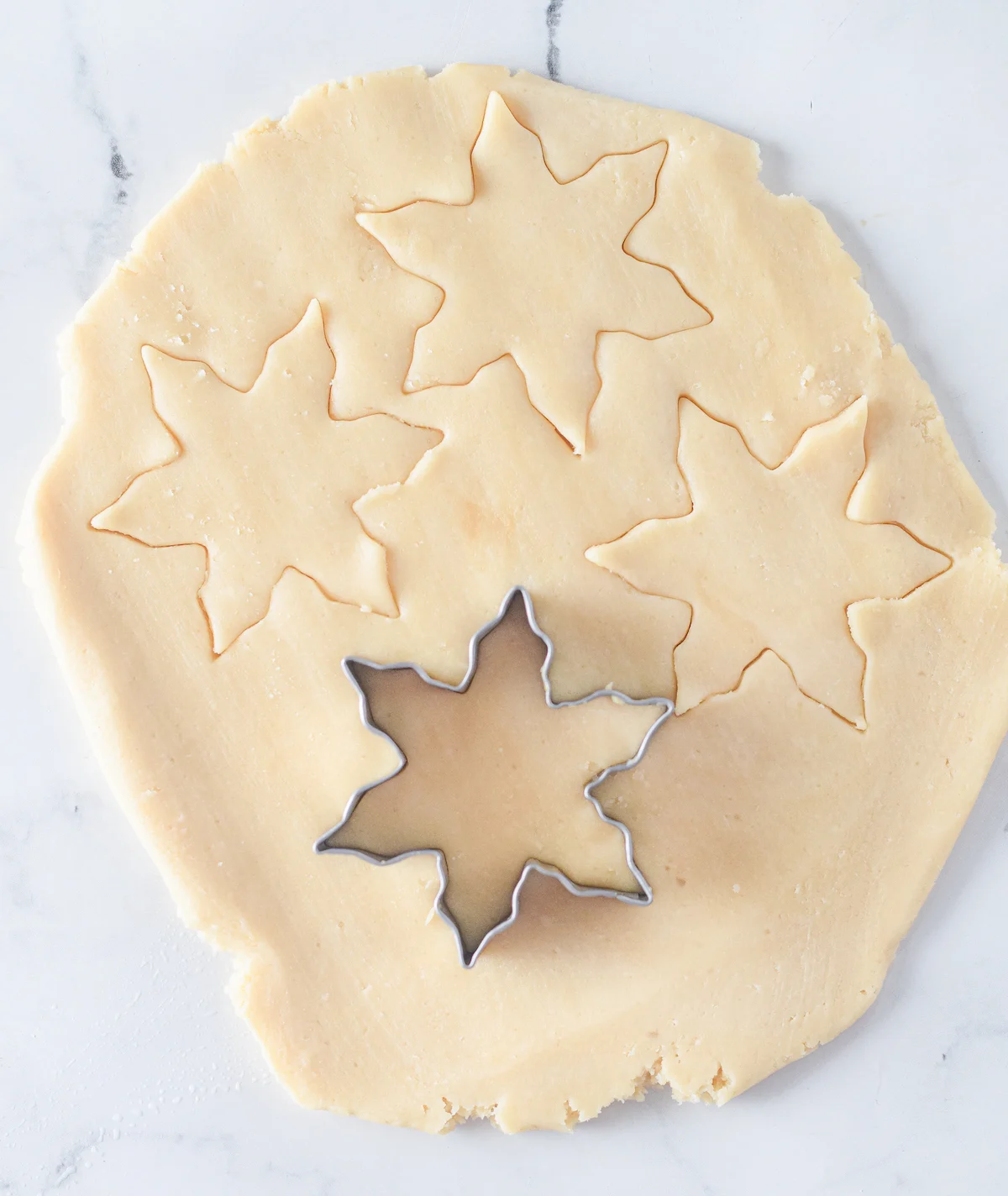 cutting star shapes out of cookie dough