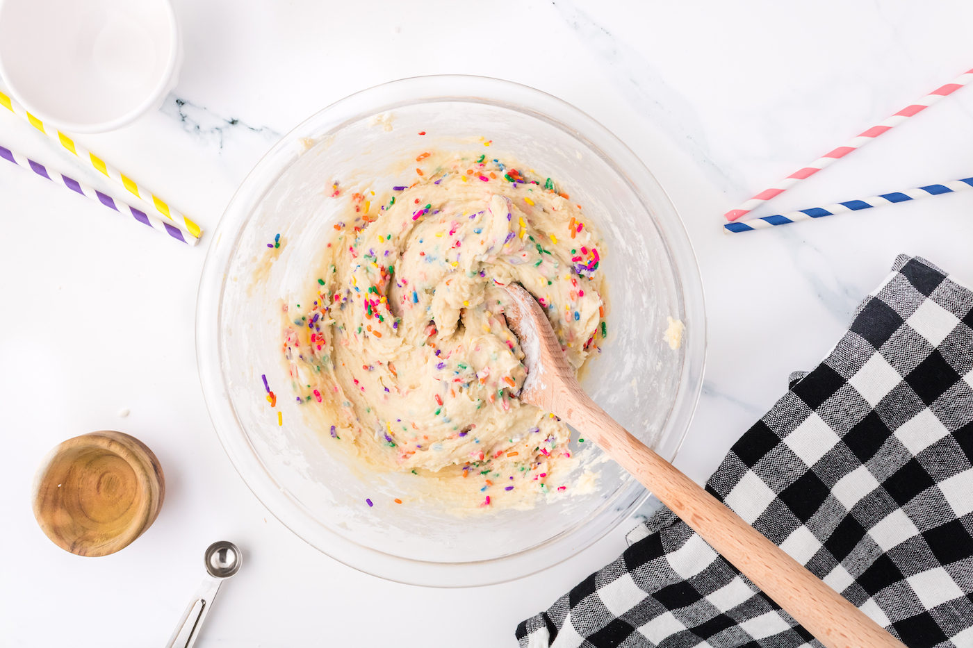 folding the sprinkles into the confetti cookie batter