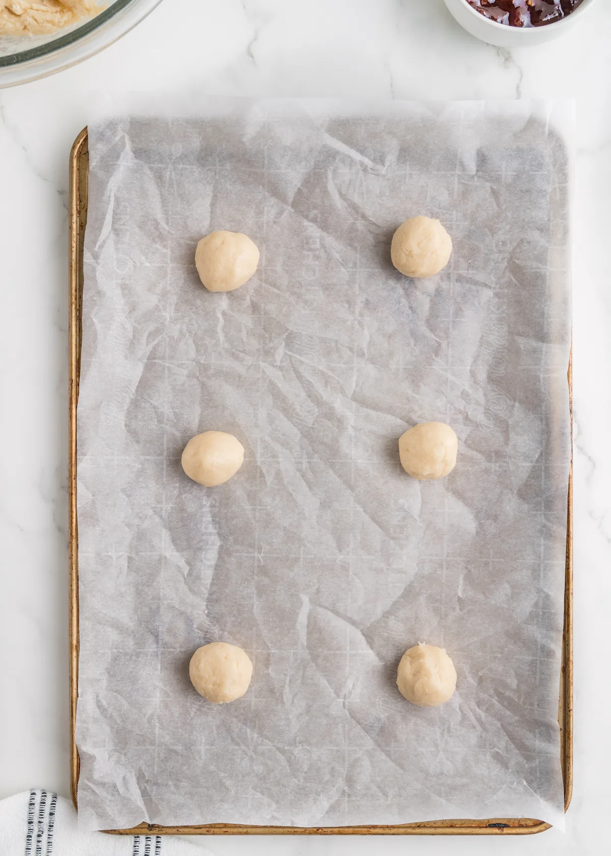 Dough placed on a baking sheet lined with parchment paper