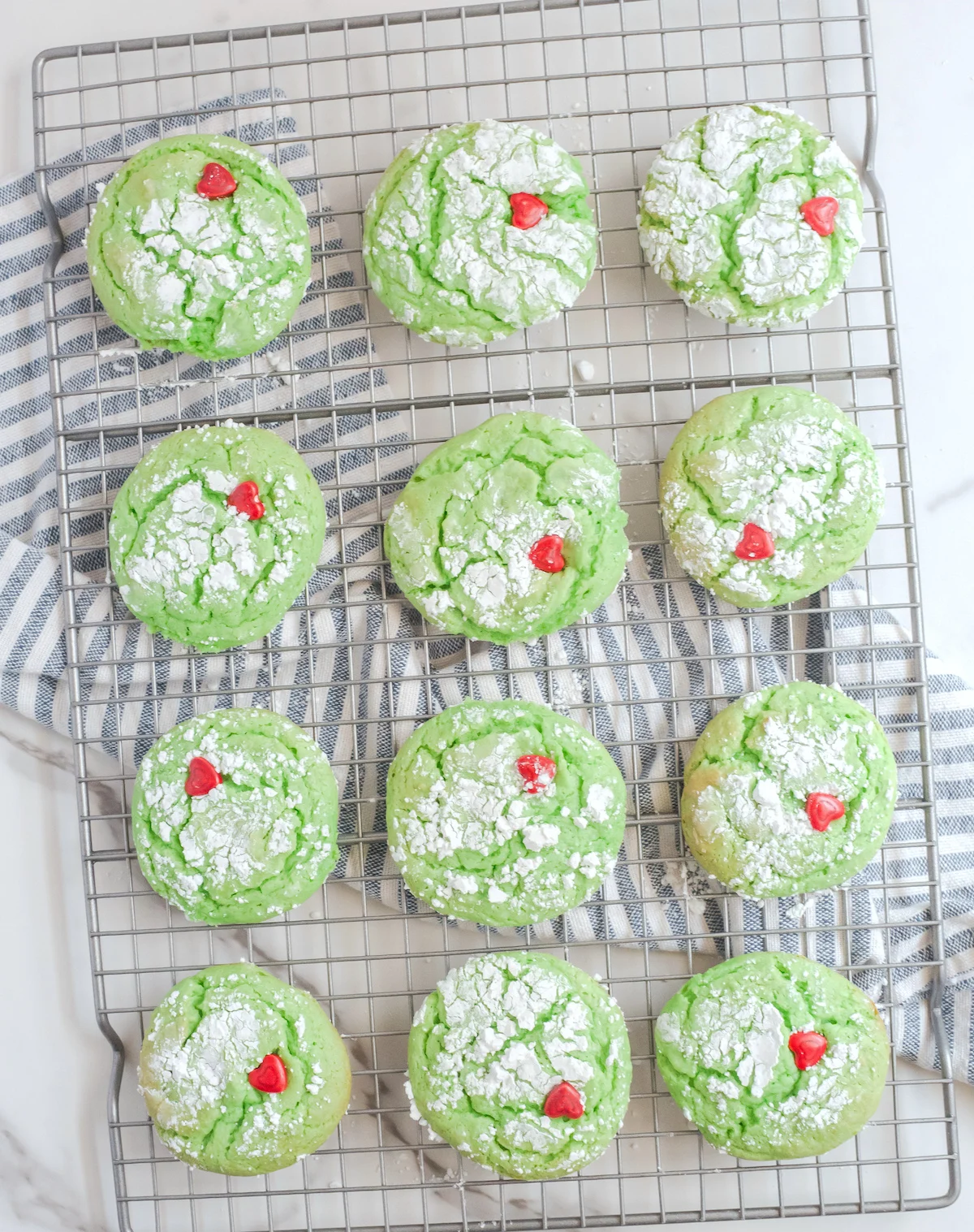 Heart shapes pressed into the green cake mix cookies