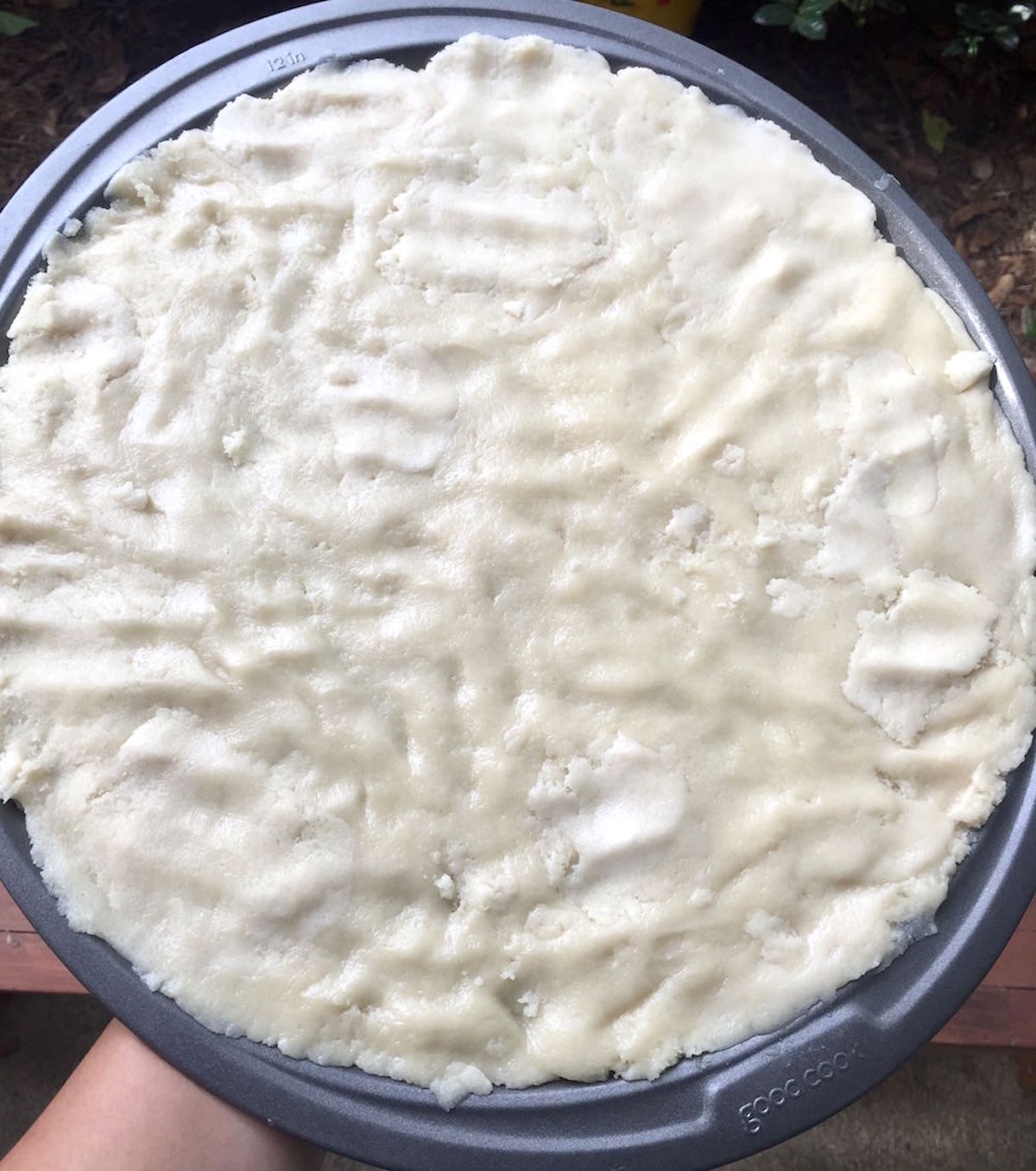 Sugar cookie dough spread to the edges of the pizza pan