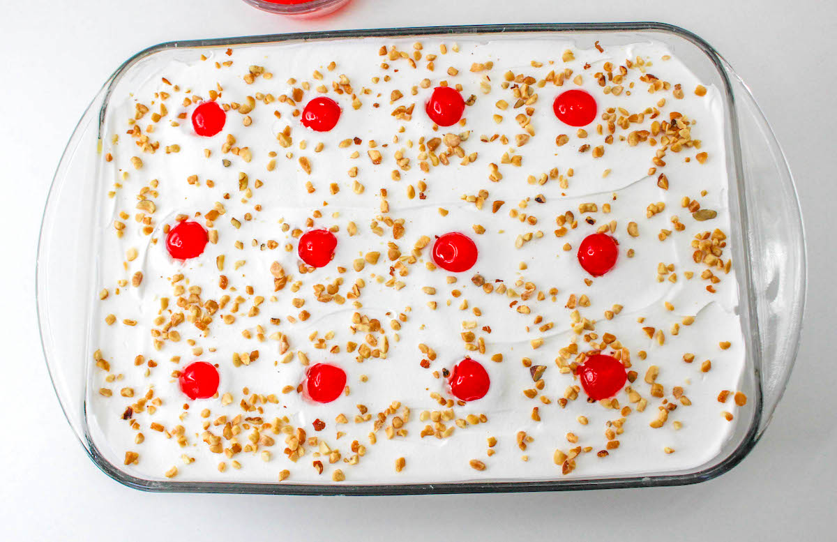 Twinkie cake topped with cherries and peanuts