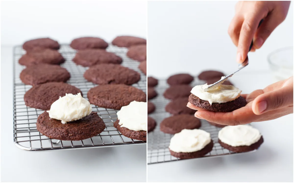 spreading icing onto the top of chocolate cookies
