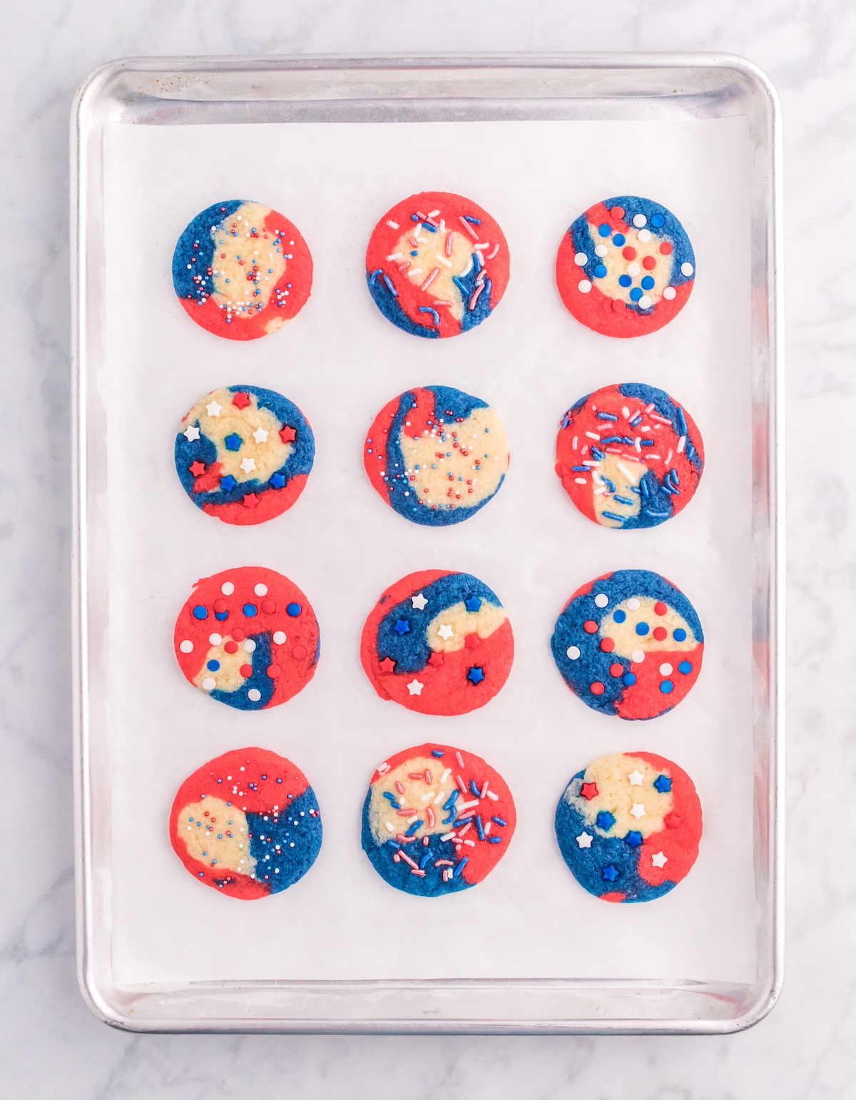 Baked red white and blue cookies on a baking sheet