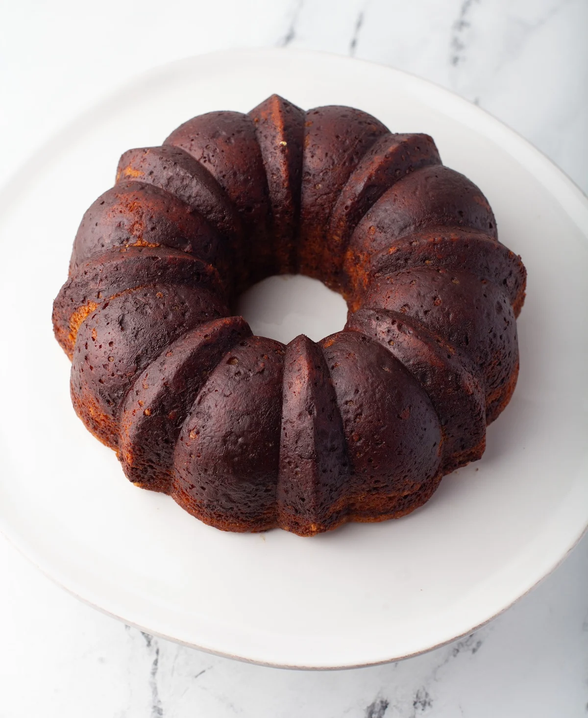 Bundt cake flipped onto a plate and cooling