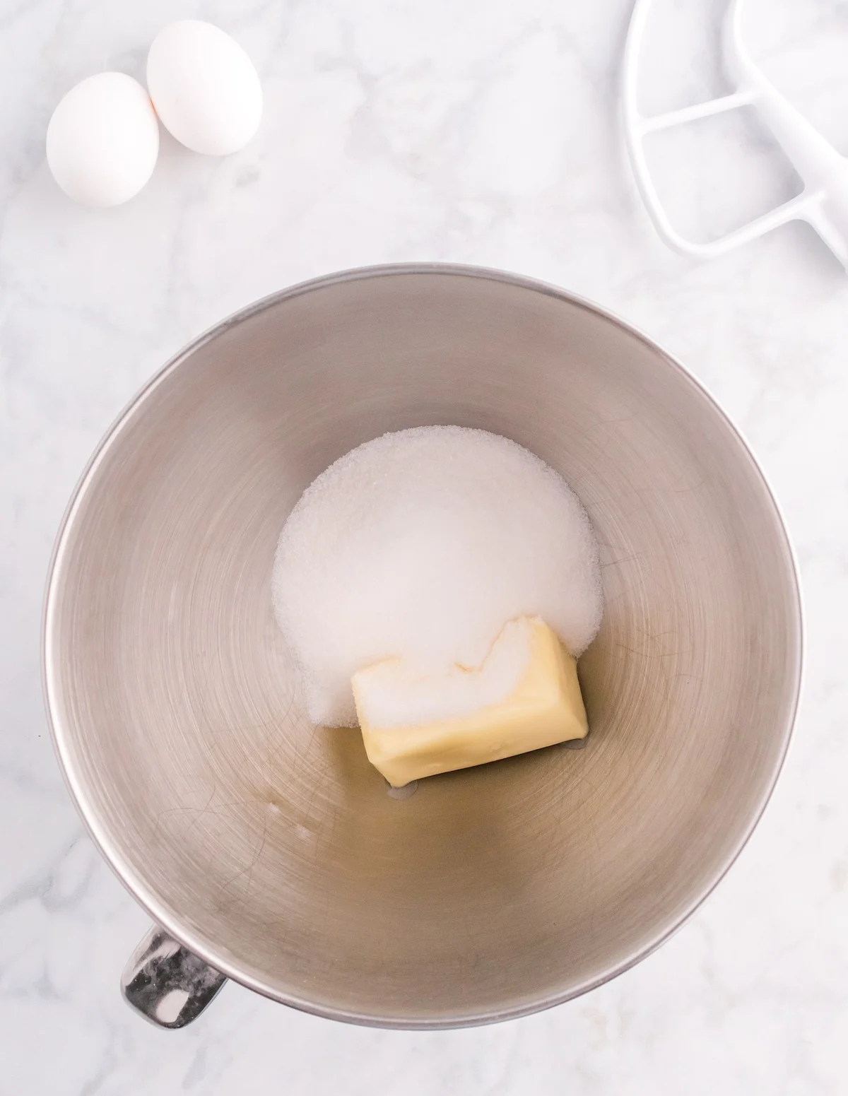 Butter and sugar together in a metal bowl